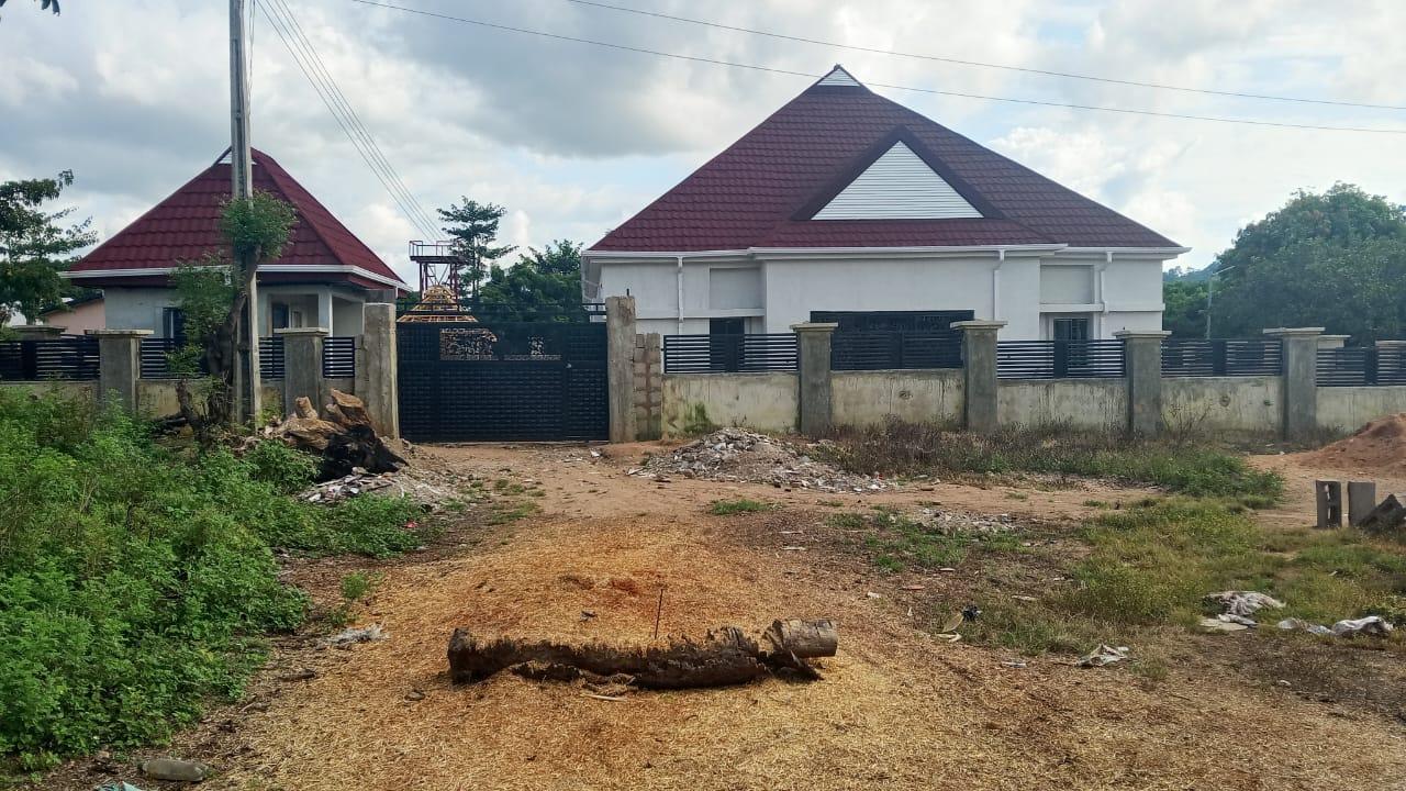 Contemporary residential building with modern roofing and perimeter fencing in Takete-Ide